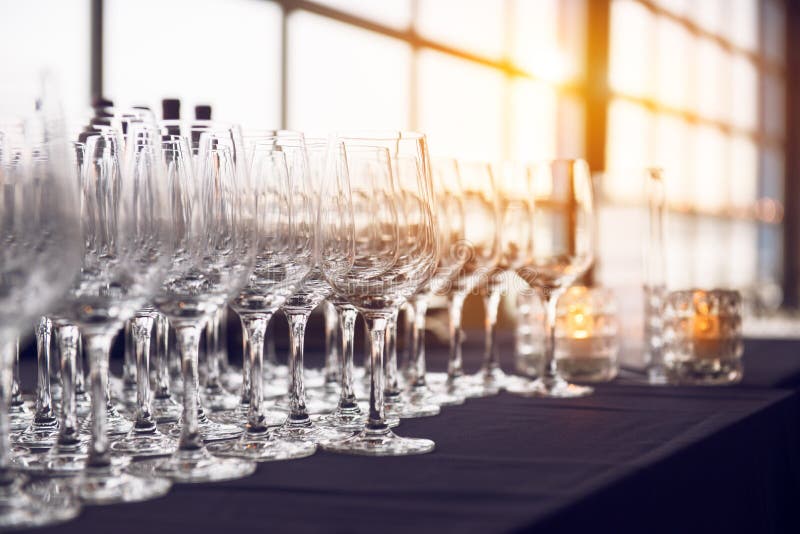 Empty wine glasses in the row in the bar before evening party and dinner