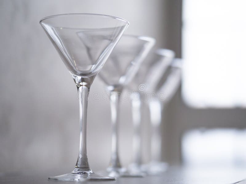 Empty wine glasses on a window sill, sea and sky in the blurred background royalty free stock images Empty wine glasses on a window sill, sea and sky in the blurred background royalty free stock images