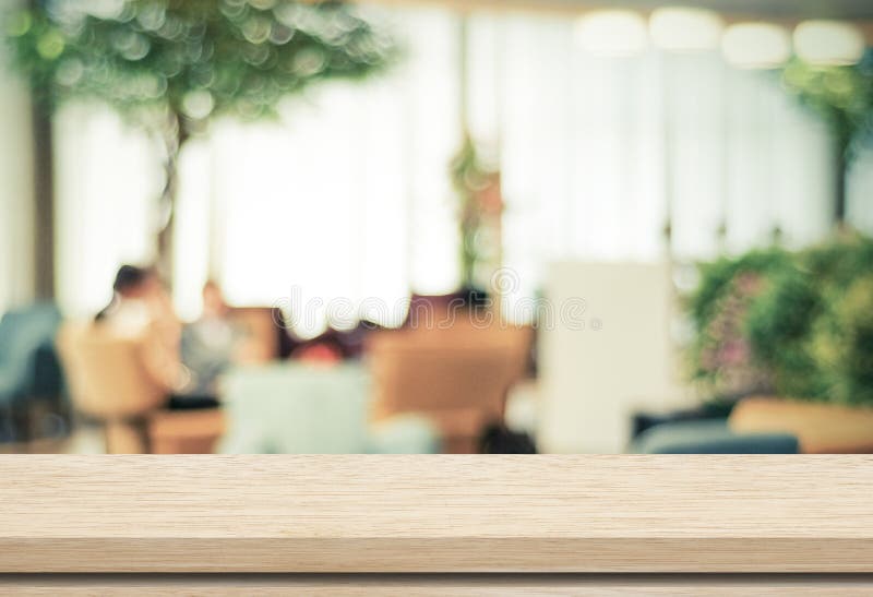 Empty wood table and blurred cafe with bokeh light background royalty free stock photo