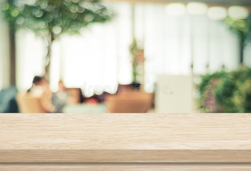 Empty wood table and blurred cafe with bokeh light background stock photography