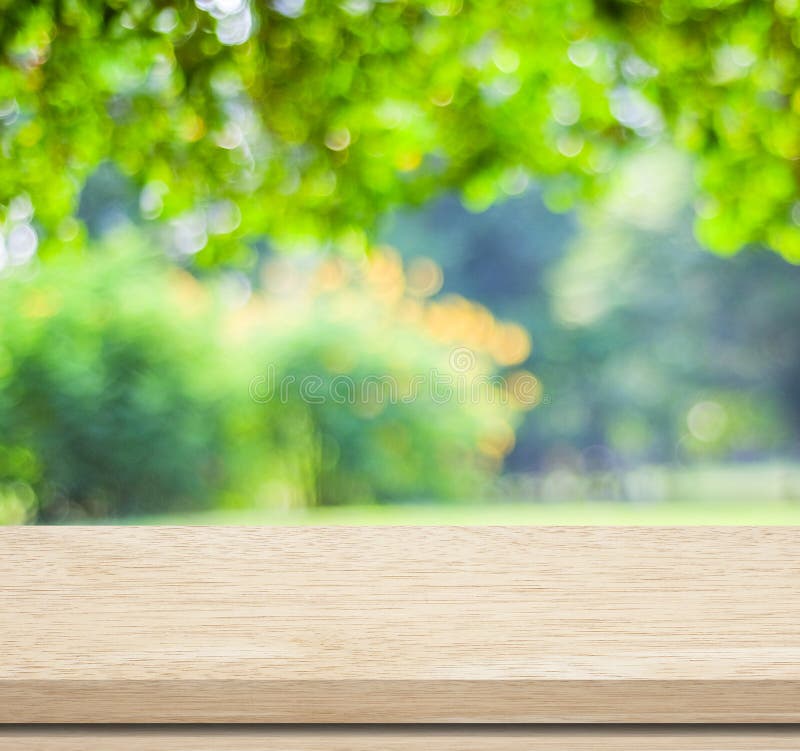 Empty wood table over blurred trees with bokeh background, product display