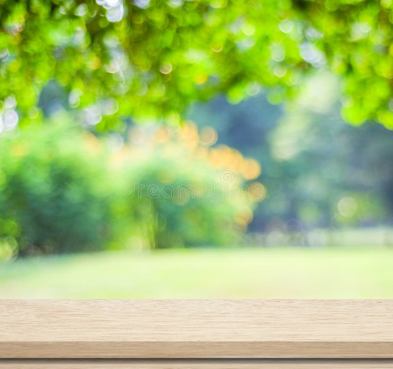 Empty wood table over blurred trees with bokeh background royalty free stock photos