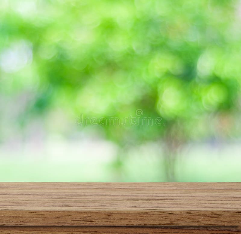 Empty wood table over blurred trees with bokeh background stock images