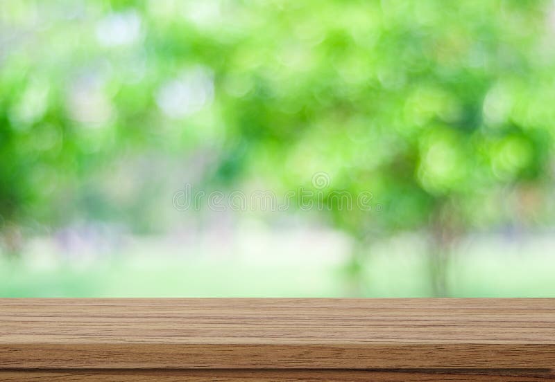Empty wood table over blurred trees with bokeh background stock photos