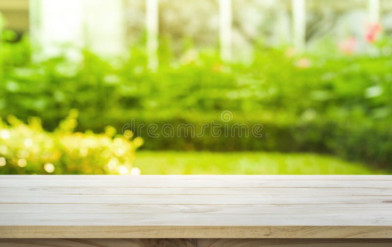 Empty wood table top on lawn green from garden in morning royalty free stock images