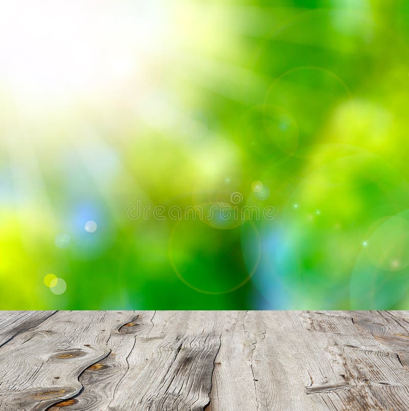 Empty wooden deck table with foliage bokeh background. stock photos