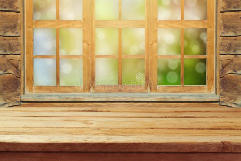 Empty wooden rustic table over window and green bokeh background royalty free stock images Empty wooden rustic table over window and green bokeh background royalty free stock images