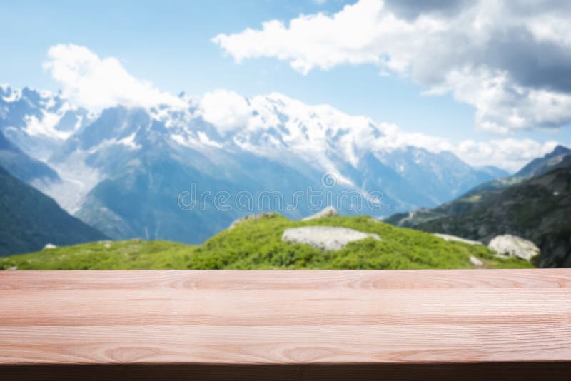 Empty wooden table on the background of scenic mountain Alpine landscape. stock images