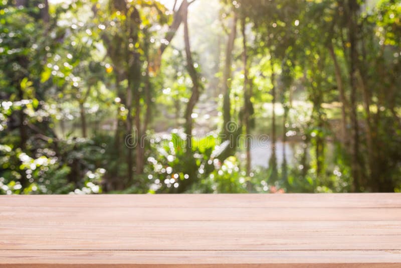 Empty wooden table with Defocus nature green bokeh, abstract nature background stock images Empty wooden table with Defocus nature green bokeh, abstract nature background stock images