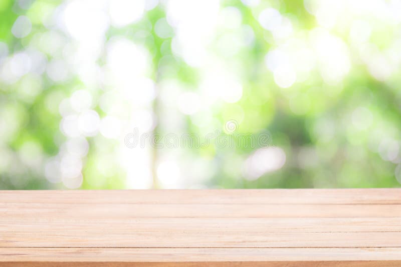 Empty wooden table with Defocus nature green bokeh, abstract nat