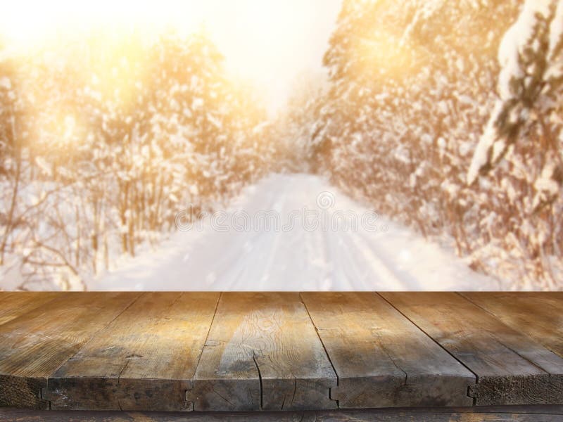 Empty wooden table in front of dreamy and magical winter landscape background. For product display montage. stock photo Empty wooden table in front of dreamy and magical winter landscape background. For product display montage. stock photo