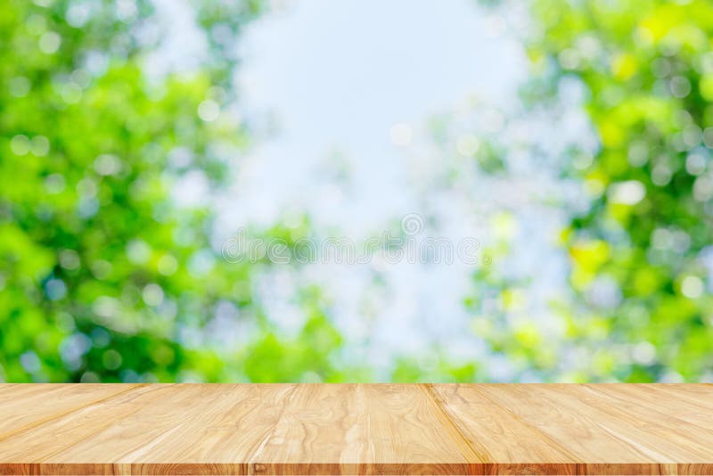Empty wooden table or shelf with. Blurred image of abstract circular green bokeh from nature background royalty free stock images