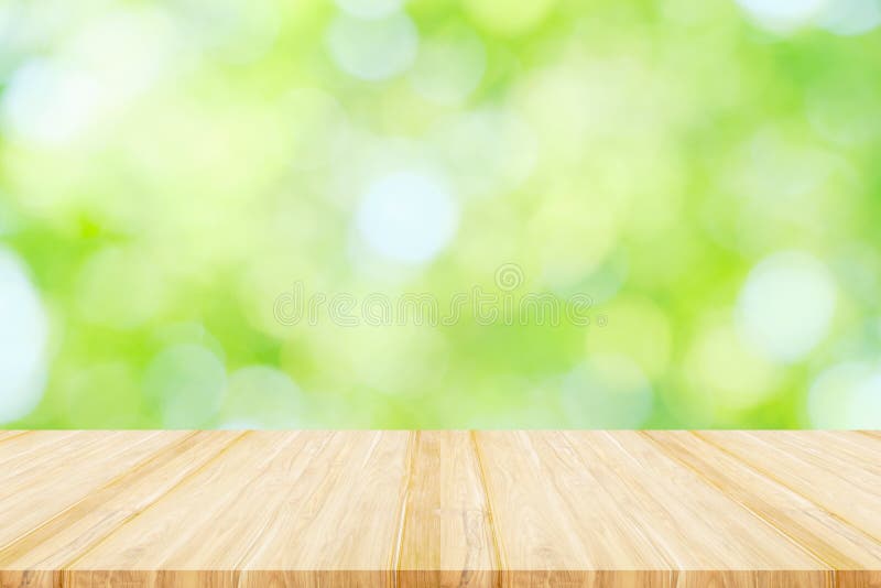 Empty wooden table or shelf with. Blurred image of abstract circular green bokeh from nature background royalty free stock image