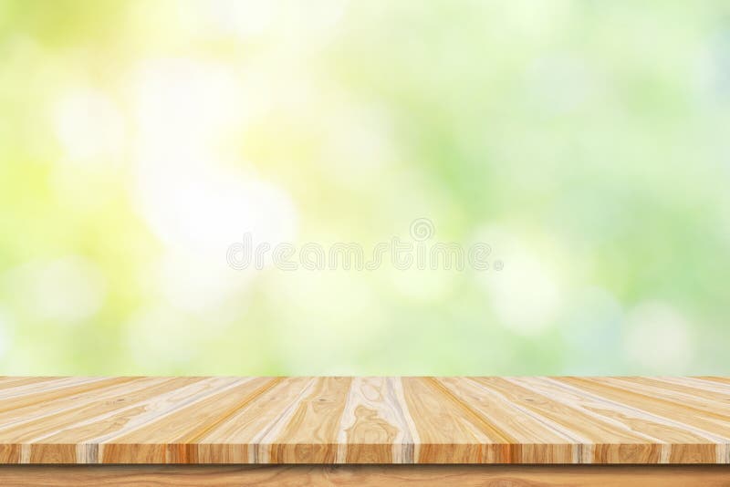 Empty wooden table or shelf with. Blurred image of abstract circular green bokeh from nature background stock photo