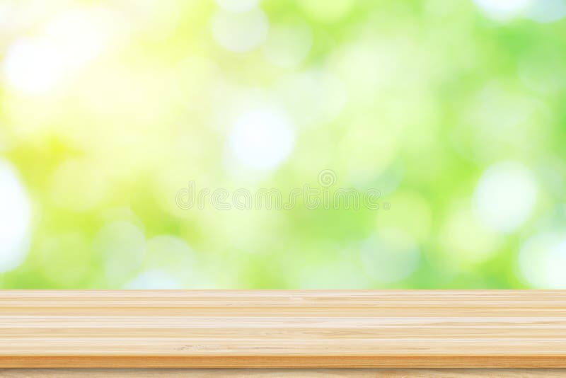 Empty wooden table or shelf with. Blurred image of abstract circular green bokeh from nature stock photos