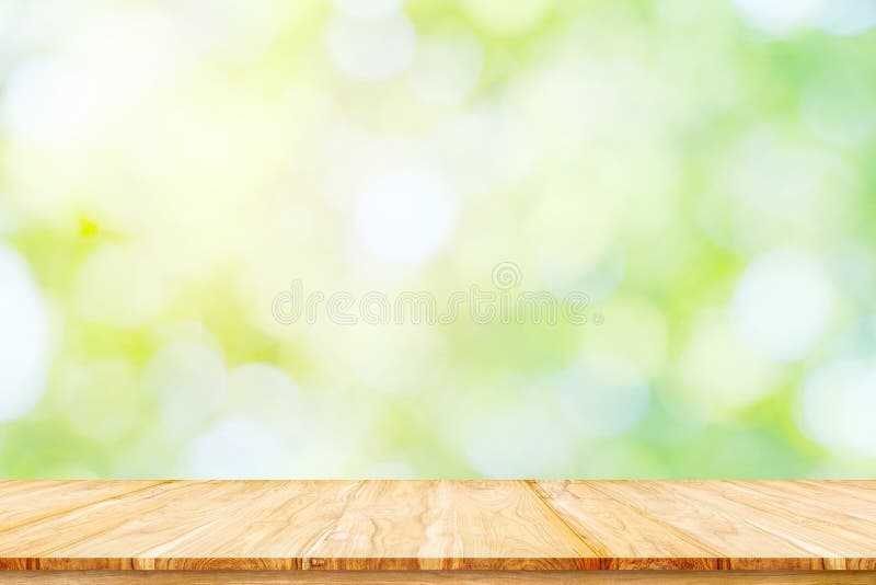 Empty wooden table or shelf with. Blurred image of abstract circular green bokeh from nature royalty free stock photography