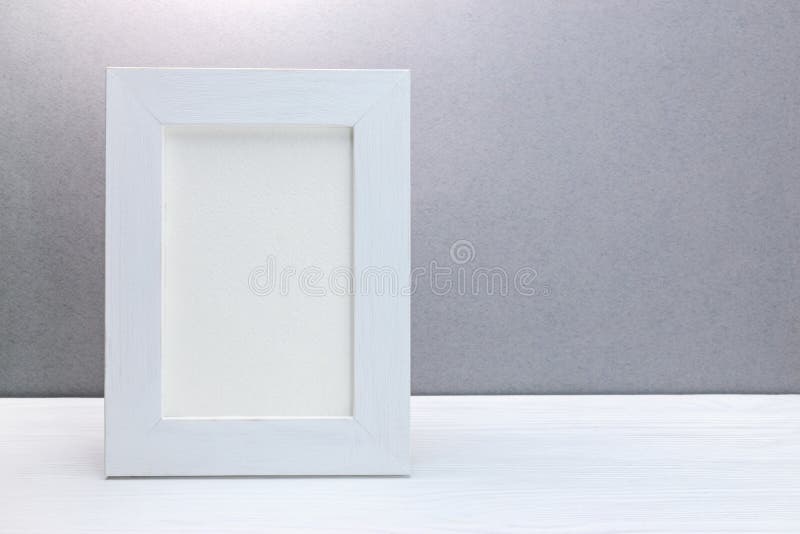 Empty wooden white photo frame against grey wall royalty free stock photos Empty wooden white photo frame against grey wall royalty free stock photos