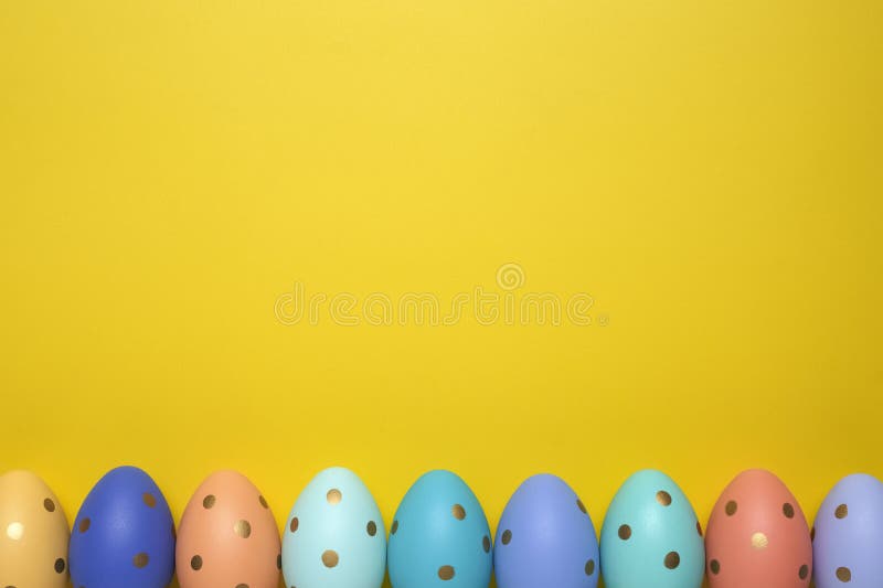 Empty yellow background with Easter eggs stock images