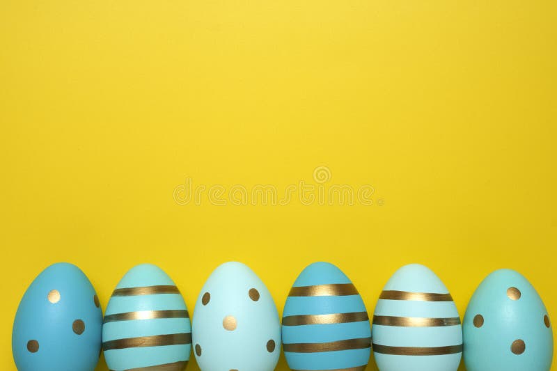 Empty yellow background with Easter eggs stock photography