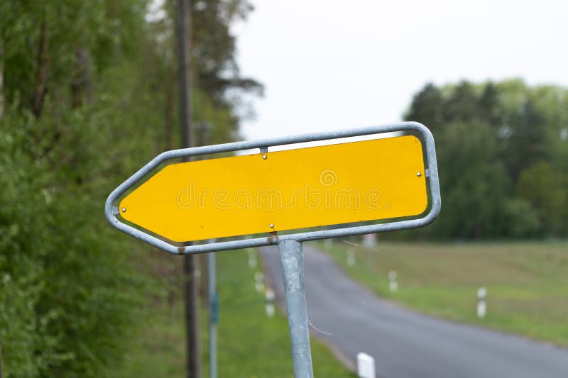 Empty Yellow Traffic Sign in an Arrow Shape Pointing to the Left royalty free stock photo