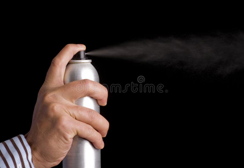 Presionar el botón de un spray para el cabello imagen de archivo