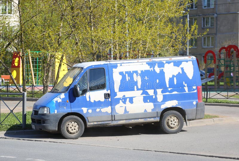 A shabby blue minibus is parked on a city street, Podvoysky street, St. Petersburg, Russia, May 02, 2024. A shabby blue minibus is parked on a city street, Podvoysky street, St. Petersburg, Russia, May 02, 2024