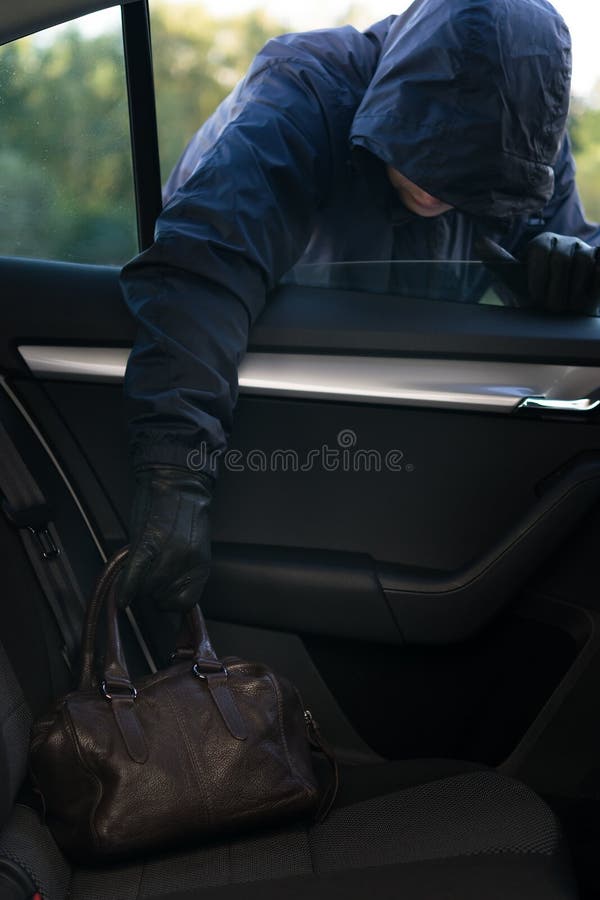 En bruna läderpåse från baksidan av en bil genom ett öppet fönster royaltyfri fotografi En bruna läderpåse från baksidan av en bil genom ett öppet fönster royaltyfri fotografi