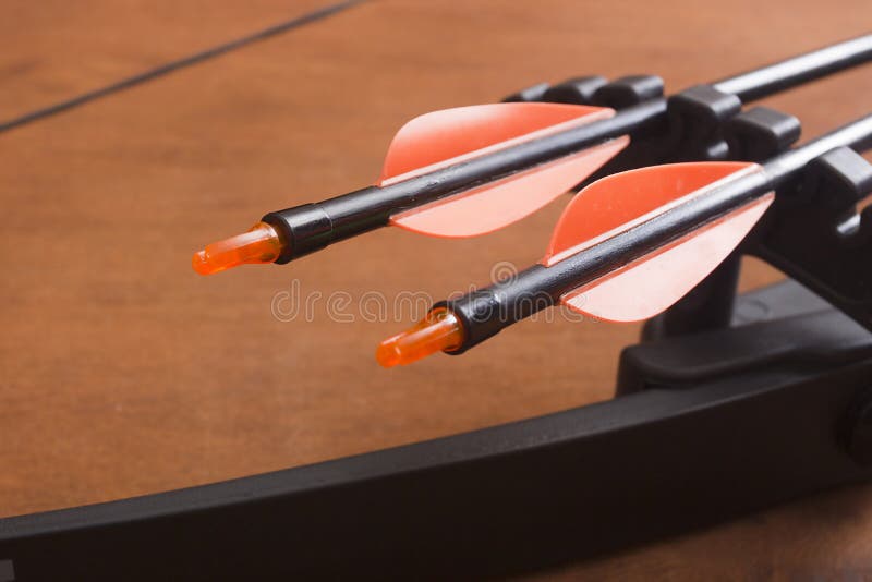 An Archery Bow and Arrows on a wooden background. An Archery Bow and Arrows on a wooden background