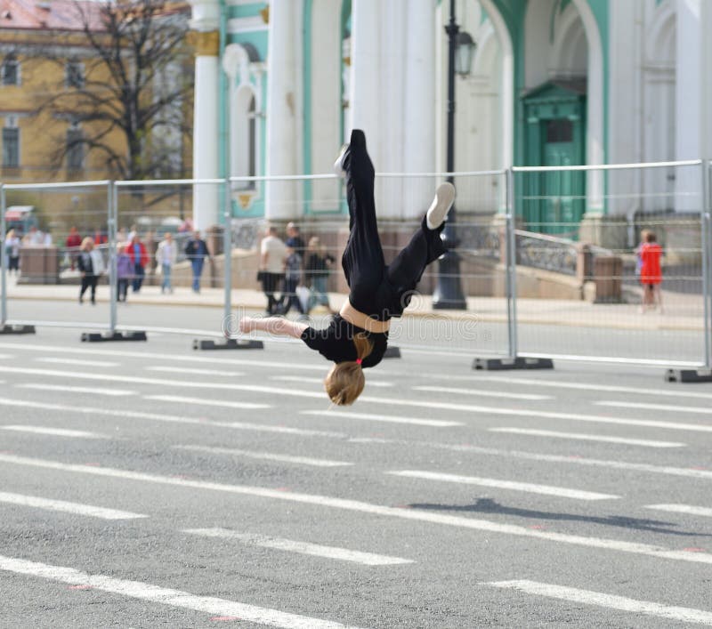 A girl does a somersault in the city square, Palace Square, St. Petersburg, Russia, April 29, 2024. A girl does a somersault in the city square, Palace Square, St. Petersburg, Russia, April 29, 2024