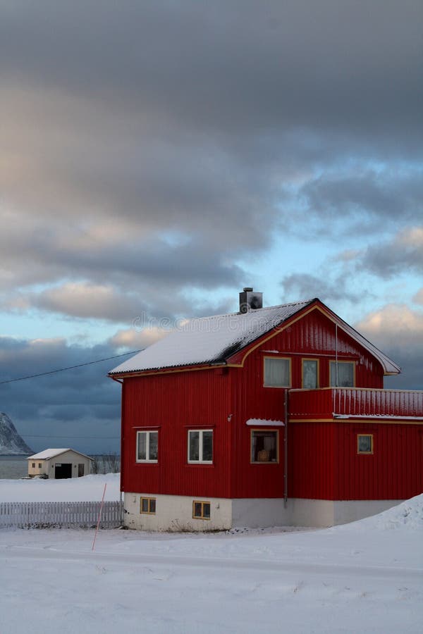 En färjapunkt av sikten av hus som täckas med insnöade Lofoten ö-Norge royaltyfri foto En färjapunkt av sikten av hus som täckas med insnöade Lofoten ö-Norge royaltyfri foto