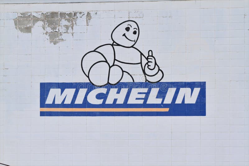 A closeup of a MICHELIN advertisement sign painted on a wall that`s bright and colorful in Hutchinson Kansas USA . A closeup of a MICHELIN advertisement sign painted on a wall that`s bright and colorful in Hutchinson Kansas USA .