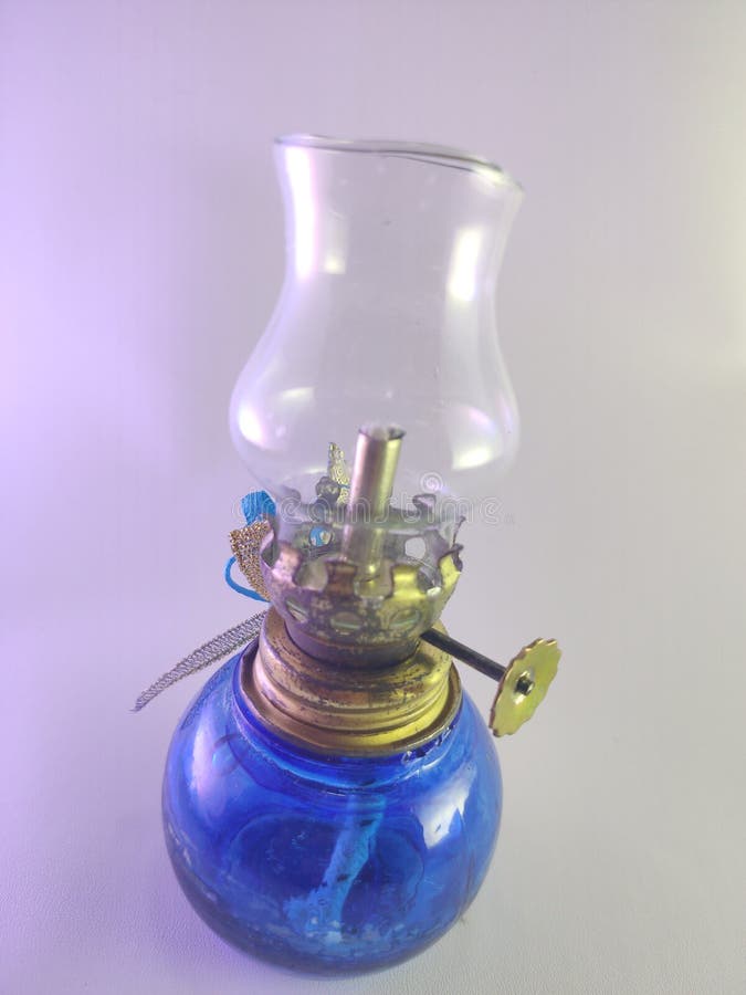 Cikarang, Indonesia- 02 December 2022: an old oil lamp, made of heat-resistant plastic, using a wick, small blue color, usually used as a wedding gift, home decoration, decorated with flowers. Cikarang, Indonesia- 02 December 2022: an old oil lamp, made of heat-resistant plastic, using a wick, small blue color, usually used as a wedding gift, home decoration, decorated with flowers