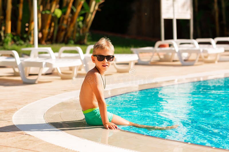 En glad liten pojke som hade kul på poolen på resorten royaltyfri bild