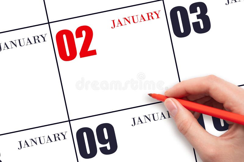 2nd day of January. A hand holding a red pen and pointing on the calendar date January 2. Red calendar date, copy space, mockup. Winter month, day of the year concept. 2nd day of January. A hand holding a red pen and pointing on the calendar date January 2. Red calendar date, copy space, mockup. Winter month, day of the year concept.