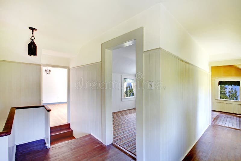 En haut couloir avec le plancher en bois dur et l'escalier photos stock En haut couloir avec le plancher en bois dur et l'escalier photos stock