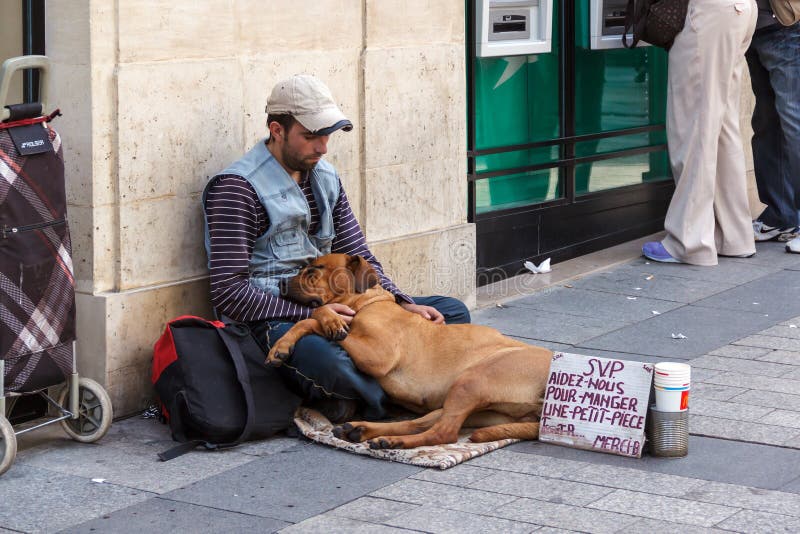 Homeless man with a dog begging on the streets of Paris. Homeless man with a dog begging on the streets of Paris