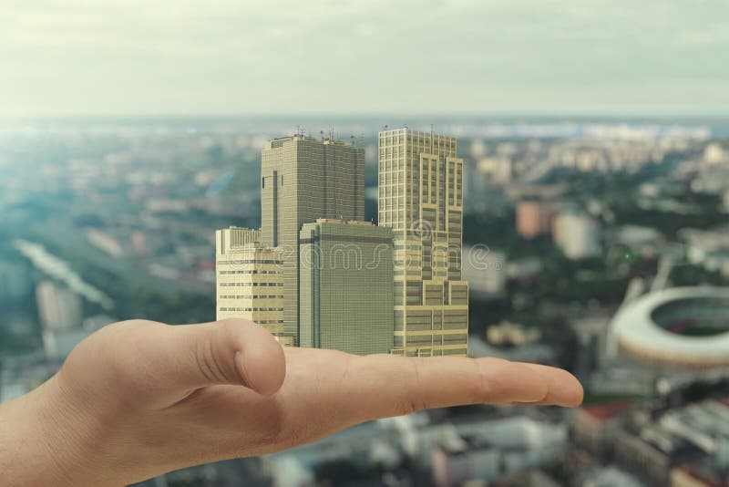 In the palm of your hand is a city block of skyscrapers. Concept: construction of new housing in the city, modern buildings,cities of the future and smart technologies. In the palm of your hand is a city block of skyscrapers. Concept: construction of new housing in the city, modern buildings,cities of the future and smart technologies.