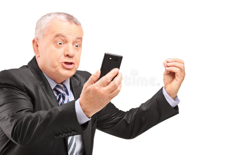 A displeased manager in suit screaming on a mobile phone isolated on white background. A displeased manager in suit screaming on a mobile phone isolated on white background