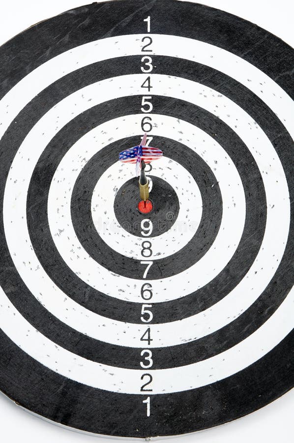 A dart with USA flag on the fletching in the center circle of a target. A dart with USA flag on the fletching in the center circle of a target