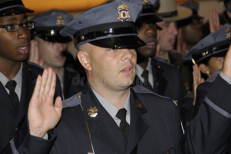 A Prince Georges County police graduate getting sworn in at the graduation of 59 new recruits in Greenbelt, Md. A Prince Georges County police graduate getting sworn in at the graduation of 59 new recruits in Greenbelt, Md