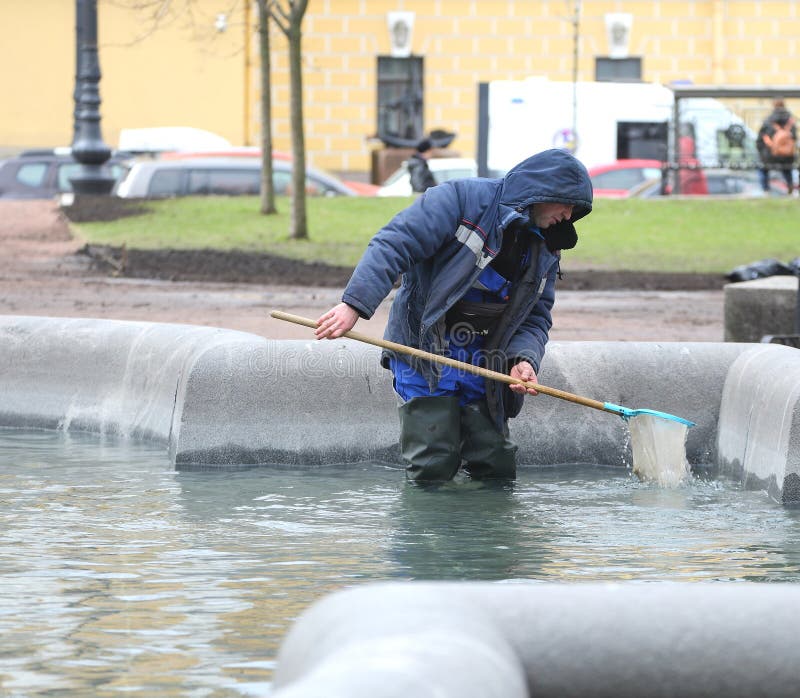 A cleaner cleans a fountain bowl from garbage, Dvortsovy Proezd, St. Petersburg, Russia, April 22, 2024. A cleaner cleans a fountain bowl from garbage, Dvortsovy Proezd, St. Petersburg, Russia, April 22, 2024