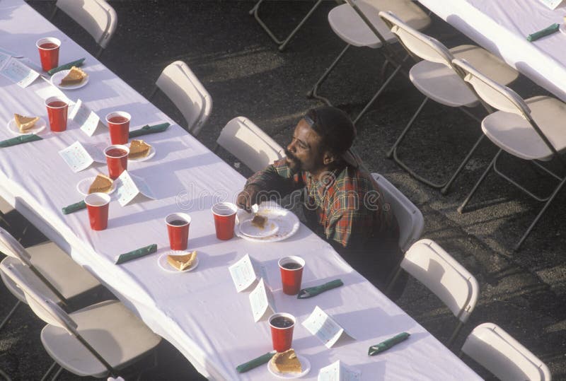 One black man eating Christmas desert at homeless shelter, Los Angeles, California. One black man eating Christmas desert at homeless shelter, Los Angeles, California