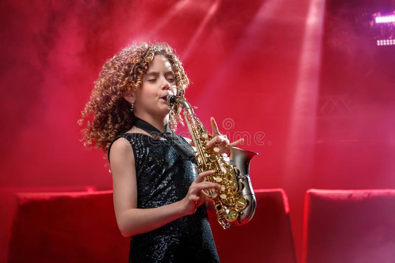 En ung musiker-flicka har saxofon royaltyfri bild