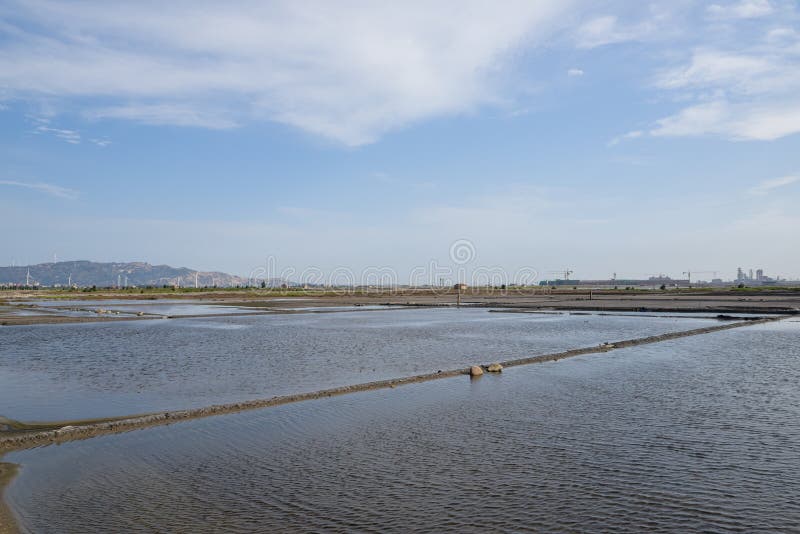 A road piled up on saline alkali land, a salt pond. A road piled up on saline alkali land, a salt pond.