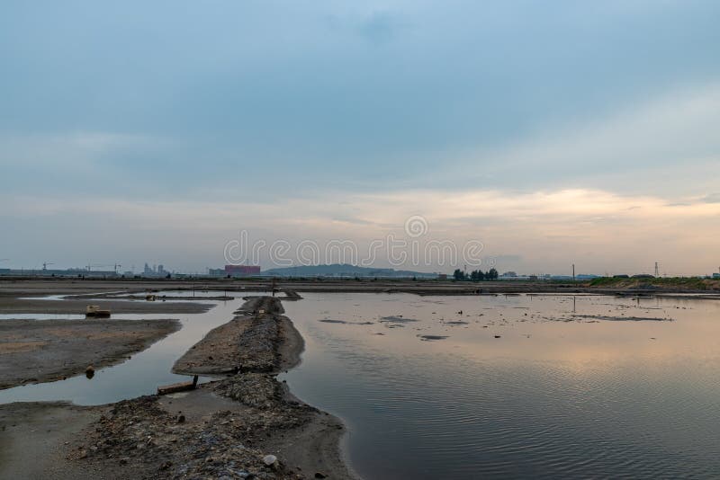 A road piled up on saline alkali land, a salt pond. A road piled up on saline alkali land, a salt pond.