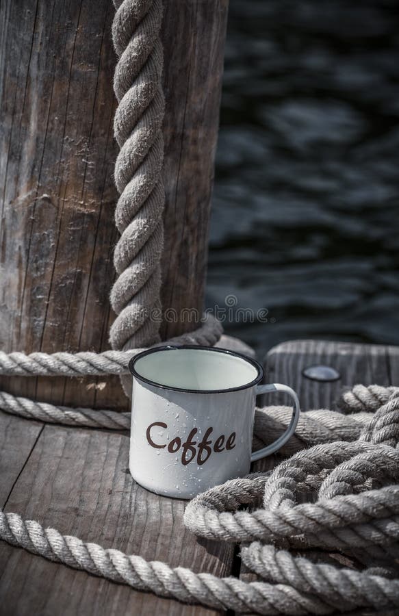 Rustic enamel coffee cup with word coffee on it and decorative