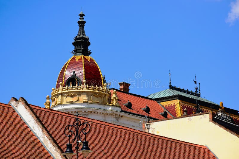Enamel finished brown clay tile roof on cupola of historic building in Pecs, Hungary