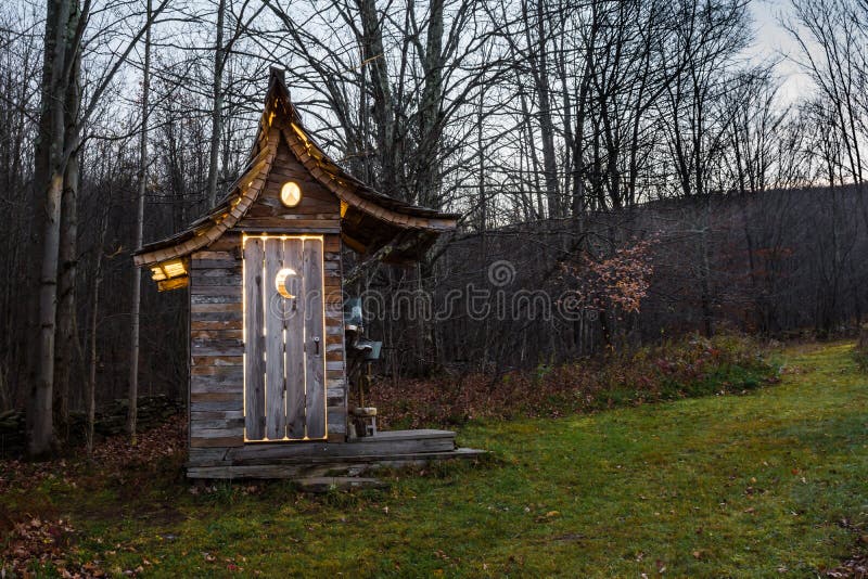 A cute glamour camping outhouse illuminated at night. A cute glamour camping outhouse illuminated at night