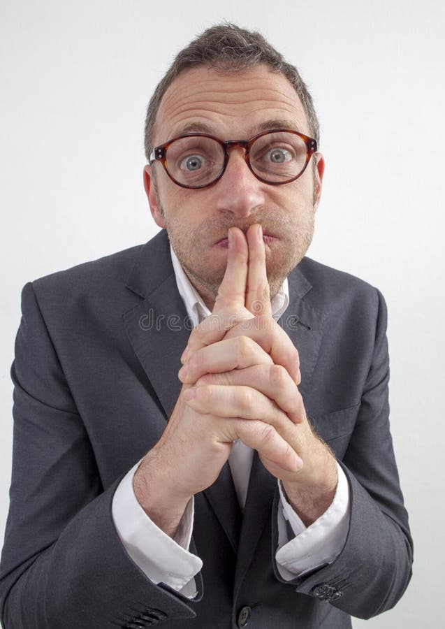 Expressive corporate man concept - funny middle age businessman with eyeglasses puffing his cheeks from management doubt or leadership resignation,wide angle on white background. Expressive corporate man concept - funny middle age businessman with eyeglasses puffing his cheeks from management doubt or leadership resignation,wide angle on white background