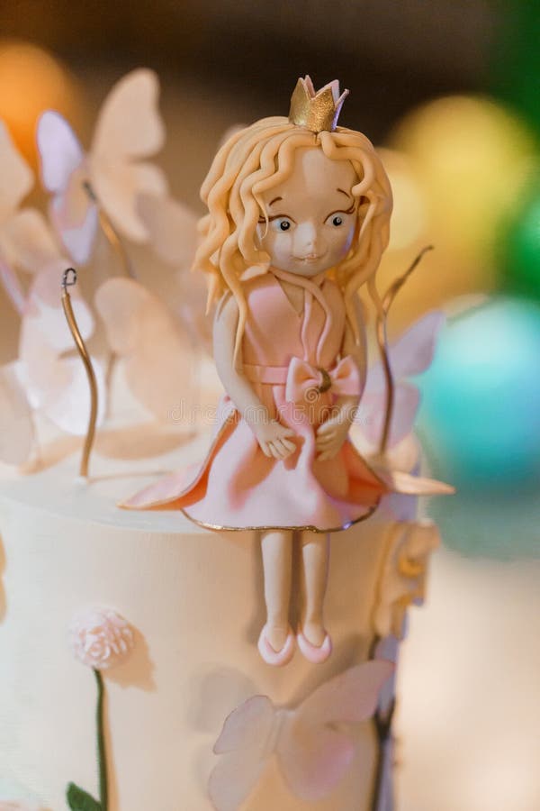 Enchanting Fairy Tale Themed Cake Decoration with Delicate Butterflies and a Fondant Figure stock photos